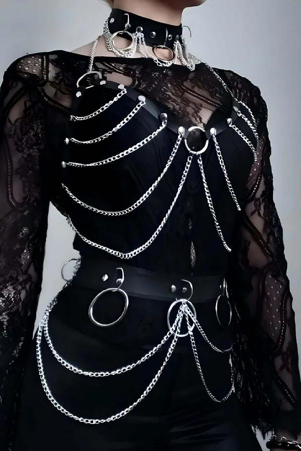 Black faux leather body harness set with cascading silver curb chains, O-rings, and matching choker layered over sheer lace t