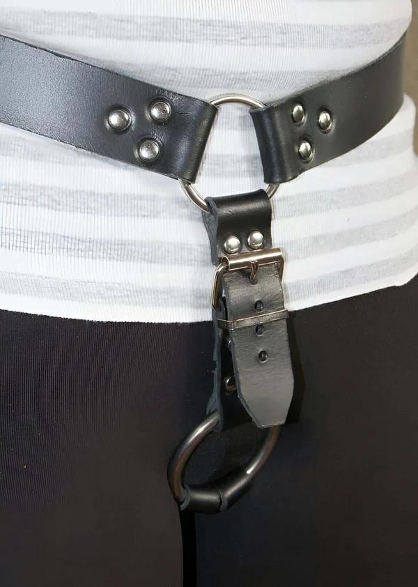 black faux leather waist harness belt with silver O-ring riveted studs and adjustable D-ring drop hook worn at waist