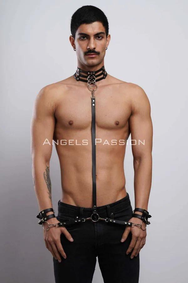 black faux leather full body harness set with multi-strap collar, vertical chest strap, and O-ring wrist cuffs on male model